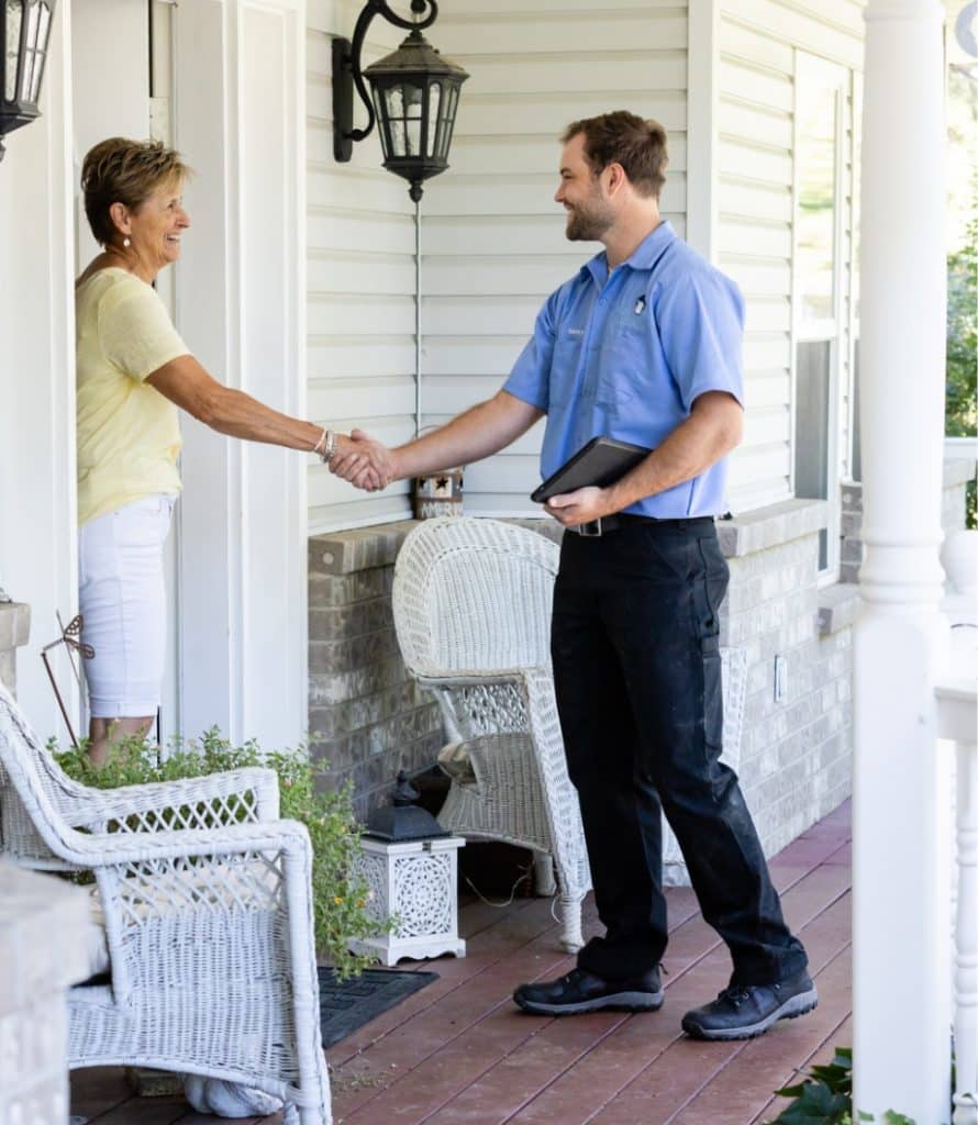 Professional Clearflow Home Services technician greeting a homeowner at the front door
